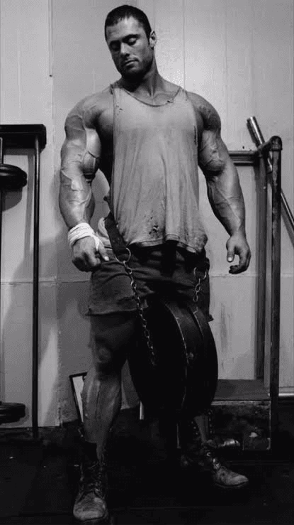 Bodybuilder facing camera with chain-loaded plates